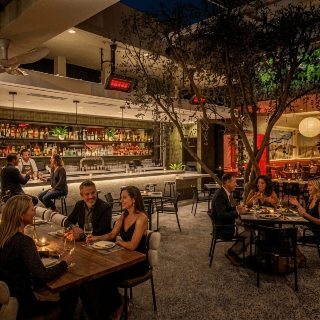 Empty bar with large tree in centre and gas heaters